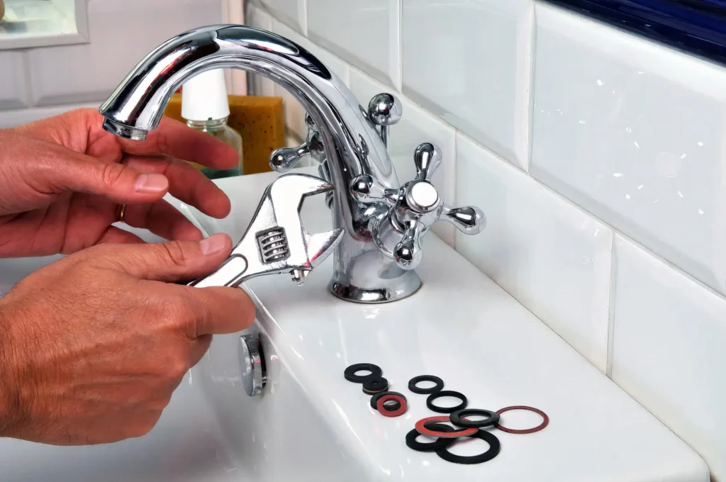 Plumber performing maintenance on a bathroom faucet in Coral Springs