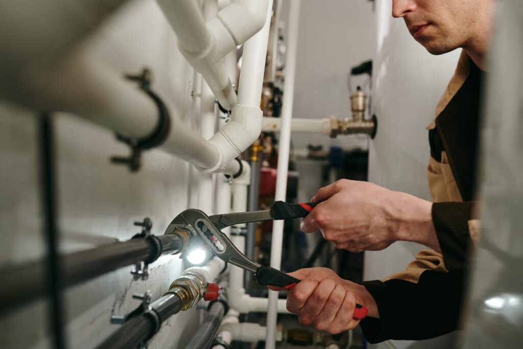 Plumbers maintaining commercial plumbing pipes in Coral Springs