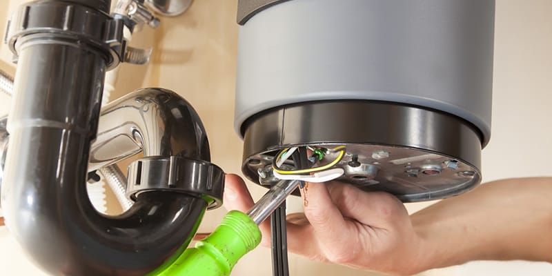 Technician repairing the heating element of a water heater in Coral Springs