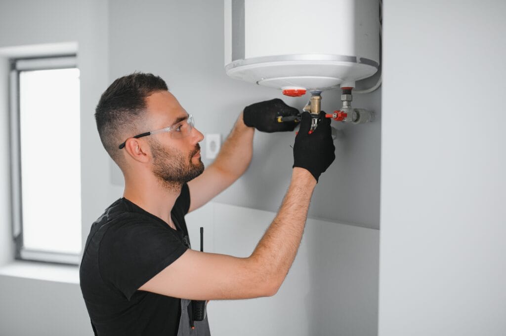 Technician performing water heater maintenance in Coral Springs